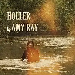 Ray standing in a waist-deep river