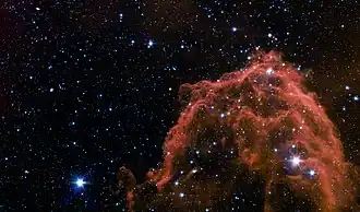 Barnard 35, a part of the Lambda Orionis Ring seen by the Spitzer Space Telescope. The Herbig-Haro Object HH 175 is part of this structure. The bright star on the lower right part of the image is FU Orionis.