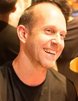 Bruce Straley smiles to the right