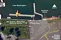 Seaplane (float plane) docks, floats, and ramp. Lake Washington at top (North), West Perimeter Road in lower-left corner. Renton Municipal Airport Perimeter fence bisects the land area at bottom (South), with personnel gate P-1 to the right and the Will Rogers - Wiley Post Memorial marker immediately to the left (East).
