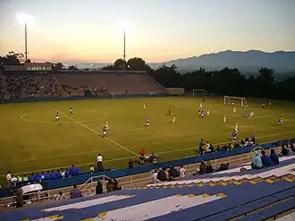 A partially filled open air soccer stadium