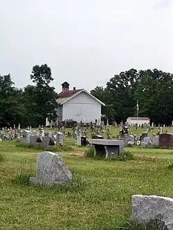 a church partially obscured by a tree