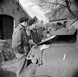 Major-General Christopher Vokes in discussion with Brigadier Robert Moncel standing in a street in Sögel on 10 April 1945