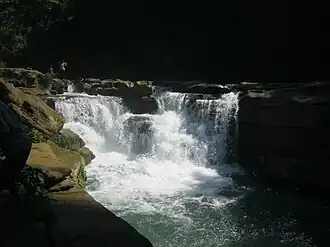 Image 66NgafaKhong (native Marma term) or Nafa-khum waterfall is situated on the Remaikree River, a tributory of Sangu river. The wild hilly Remaikree river suddenly falls down here about 25–30 feet. The falls are located in a remote area two hours' walking distance from Remakree bazar, Thanchi Upazila, Bandarban District. Photo Credit: Abu Md. Jakaria