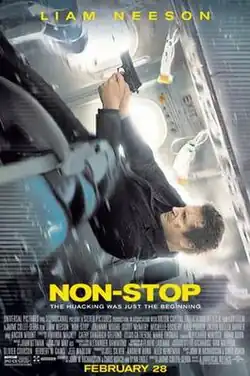 A man falling back along an airplane, firing a gun.