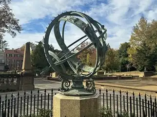 Bronze sphere surrounded by a fence