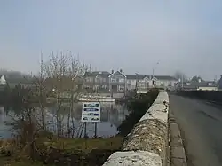a view over a river bridge to a hotel on the opposite bank