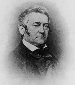 A black and white portrait of an older John Silva Meehan