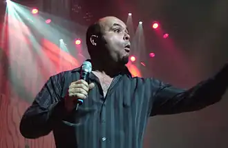 Tyler Stewart onstage, holding a microphone